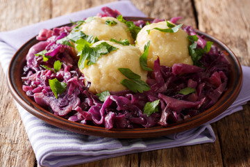 Vegetarian food potato dumplings with stewed red cabbage salad close-up on a plate. horizontal