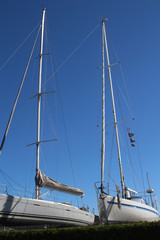 Obraz premium Sailing boats in dry-dock against blue sky