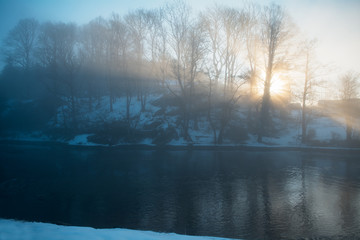 Fototapeta na wymiar A beautiful winter landscape scenery where the sun rises over the hill