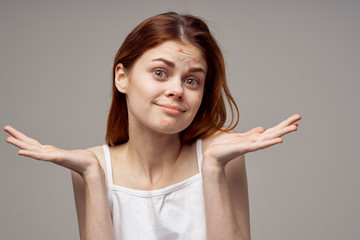 woman from pimples on the forehead spreads her hands