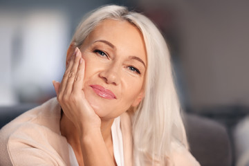 Portrait of smiling mature woman at home