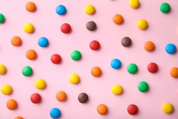 Tasty glazed candies on color background, top view