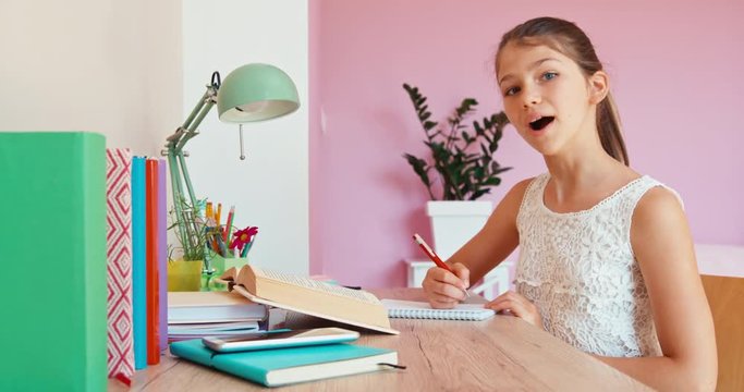 Cute girl studying at home