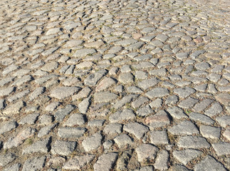 Rough surface of an old cobblestone road