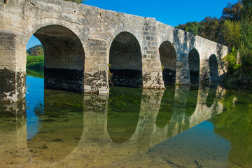 Fototapeta na wymiar Stone bridge on river Dobra in Novigrad, Karlovac county, Croatia 