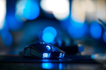 Gaming blue illuminated mouse isolated in dark.Pc gaming mouse. Computer mouse close up.