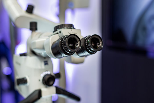 Dental microscope on the background of modern dentistry. Medical equipment. Dental operating microscope with rotary double binocular.
