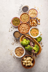 Vegan protein source. Tofu, beans, chickpeas, nuts and seeds on a white background, top view, copy...