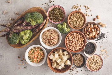Vegan protein source. Tofu, beans, chickpeas, nuts and seeds on a white background, top view, copy space.