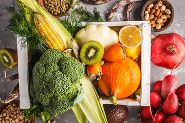 Fruits, vegetables and cereals in a wooden box, top view, healthy food background.