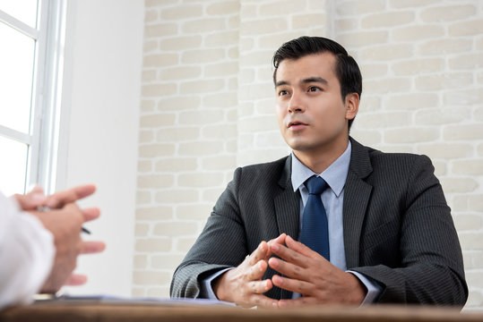 Businessman negotiating with client at the table before making an agreement