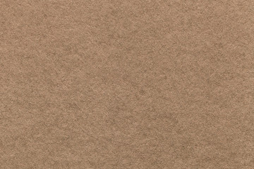 Fototapeta na wymiar Texture of old light brown paper background, closeup. Structure of dense cardboard