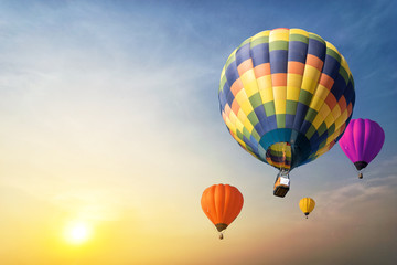 Fototapeta premium Colorful balloons floating in the sky at sunset.