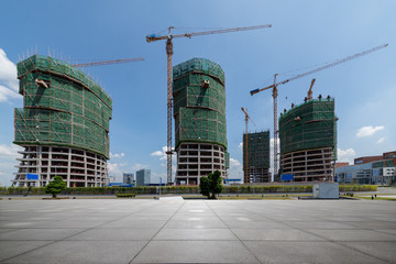 Construction site and empty concrete square buildings