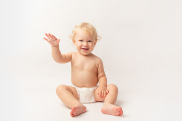 Infant child baby girl in diaper laughs happy looking at the camera isolated on a white background