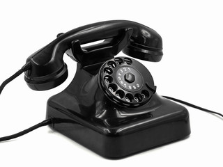 old vintage black rotary dial telephone isolated on white background, retro bakelite phone