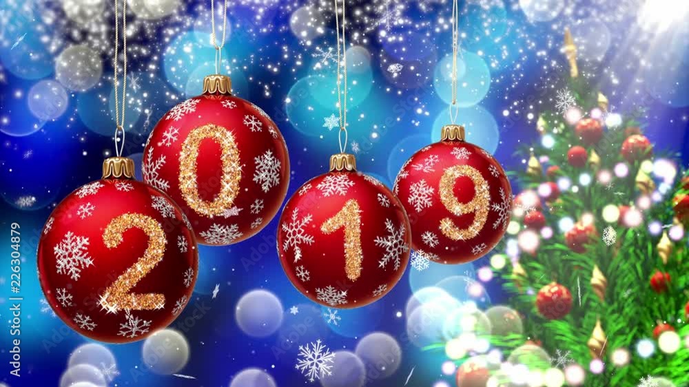 Wall mural red balls with numbers 2019 hanging on the background of a blue bokeh and a rotating christmas tree 