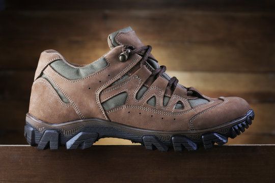 Hiking boot on wooden background