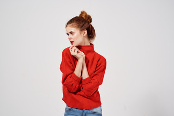 pretty woman in red sweater on bright background