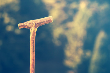 walking stick in the mountain, detail of object that is a symbol of hiking activity