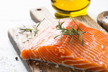 Uncooked salmon fillet with lemon sea salt and rosemary on white