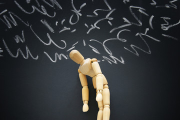 image of wooden dummy with worried stressed thoughts. depression, obsessive compulsive, adhd,...