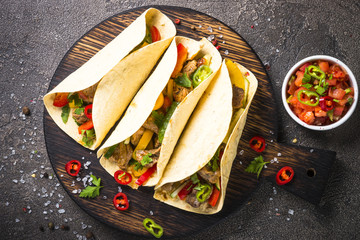 Mexican pork tacos with vegetables and salsa.