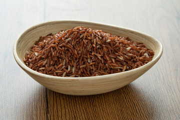 brown rice for healthy wood bowl on wood background
