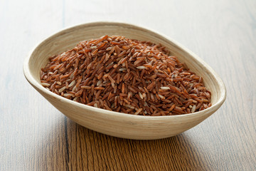 brown rice for healthy wood bowl on wood background