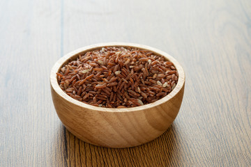 brown rice for healthy wood bowl on wood background