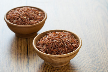 brown rice for healthy wood bowl on wood background