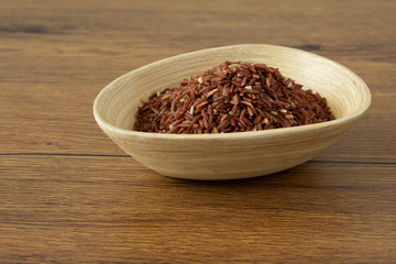 brown rice for healthy wood bowl on wood background
