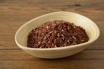 brown rice for healthy wood bowl on wood background