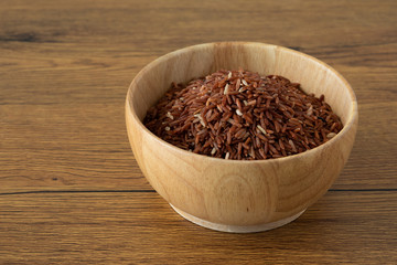 brown rice for healthy wood bowl on wood background