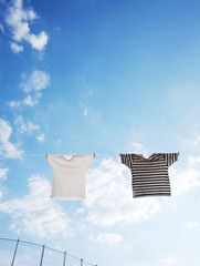 Hung out to dry cloths in the bright sky and warm sun     