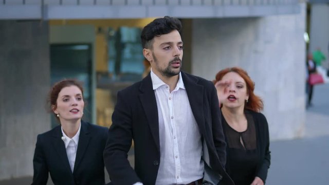 Quarrel among group of business people.Competition, man against woman - outdoor