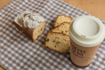 Sweet cake and coffee to go. Homemade bun.