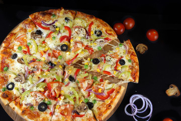 Bright, beautiful, colorful pizza, cut into pieces, top view