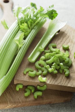 Celery on wooden chopping board