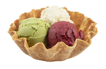 Three scoops of natural organic fruit ice cream in a wafer cup isolated on white.