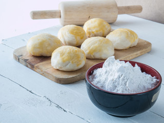 pastry flour in black cup on white wooden background, cookies on wood,