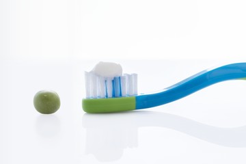 Toothbrush with pea sized amount of toothpaste