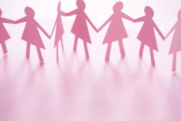 Pink cut out paper chain female figures