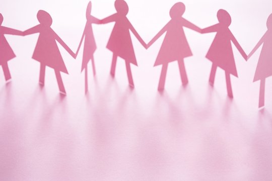 Pink cut out paper chain female figures