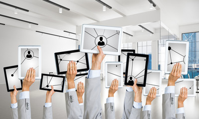 Close of businessman hands in line showing tablet pc presenting social connection concept. Mixed media