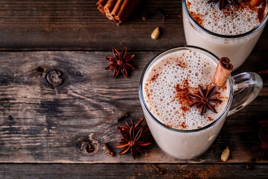 Homemade Chai Tea Latte With Anise And Cinnamon Stick In Glass Mugs