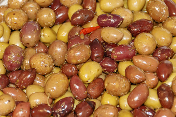 Salty fruits of olive tree with red pepper. view from above