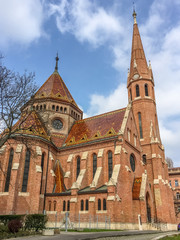 Fototapeta premium Church inside city with nice blue sky and clouds