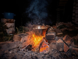 vacationers are roasted on the fire in a pot tasty meal