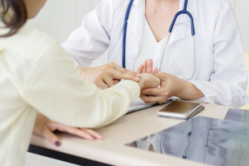 Female doctor talking to patient.Doctor and patient discussing something while sitting at the table . Medicine and health care concept. Doctor and patient